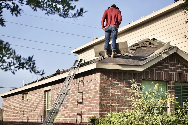 Professional roofer working on a residential roof in Rancho La Costa